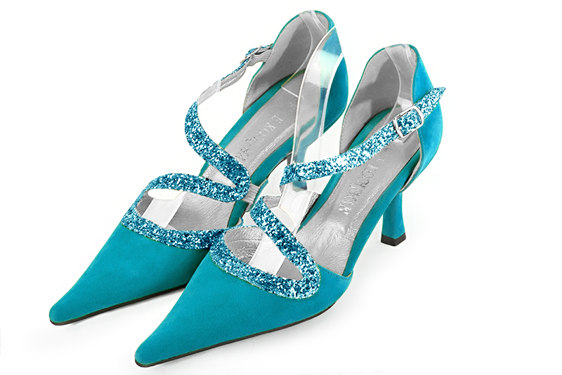 Turquoise blue open side shoes with snake shaped straps. Pointed toe. High slim heel